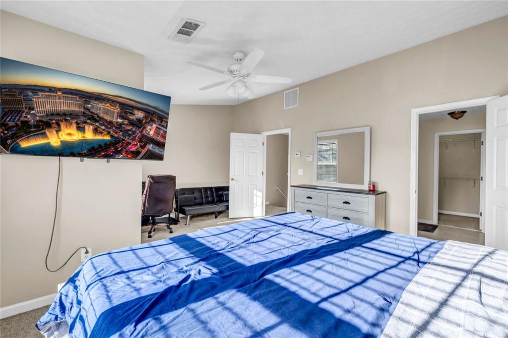 1246 Adcox Square Stone Mountain, GA 30088 - Photo 14 of 22 a bedroom with a bed and a chandelier