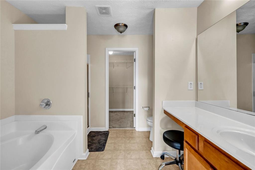 1246 Adcox Square Stone Mountain, GA 30088 - Photo 16 of 22 a bathroom with a sink a toilet and shower