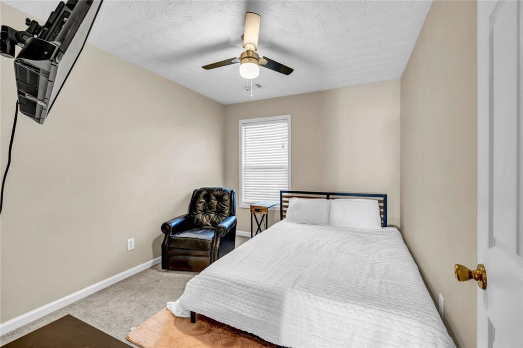 1246 Adcox Square Stone Mountain, GA 30088 - Photo 21 of 22 a bedroom with a bed and a couch