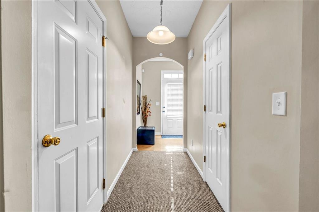 1246 Adcox Square Stone Mountain, GA 30088 - Photo 6 of 22 a view of a hallway with wooden floor and windows