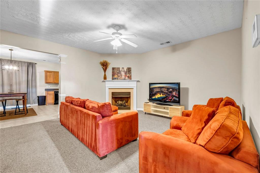 1246 Adcox Square Stone Mountain, GA 30088 - Photo 7 of 22 a living room with furniture and a fireplace