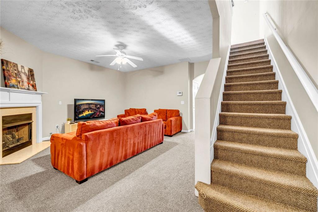 1246 Adcox Square Stone Mountain, GA 30088 - Photo 8 of 22 a living room with furniture and a fireplace