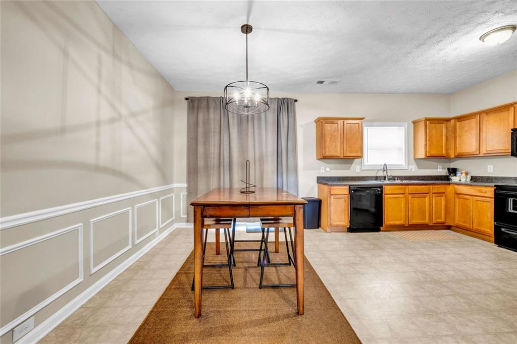 1246 Adcox Square Stone Mountain, GA 30088 - Photo 10 of 22 a kitchen with granite countertop sink stove and refrigerator