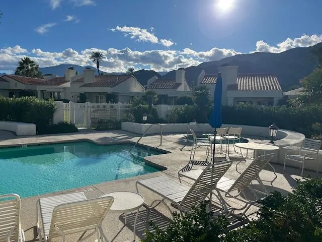 a view of a patio with couches table and chairs and potted plants