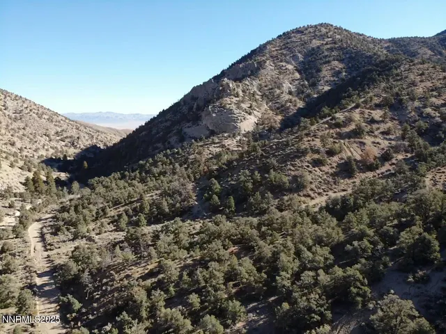 a view of a large building with mountains in the background