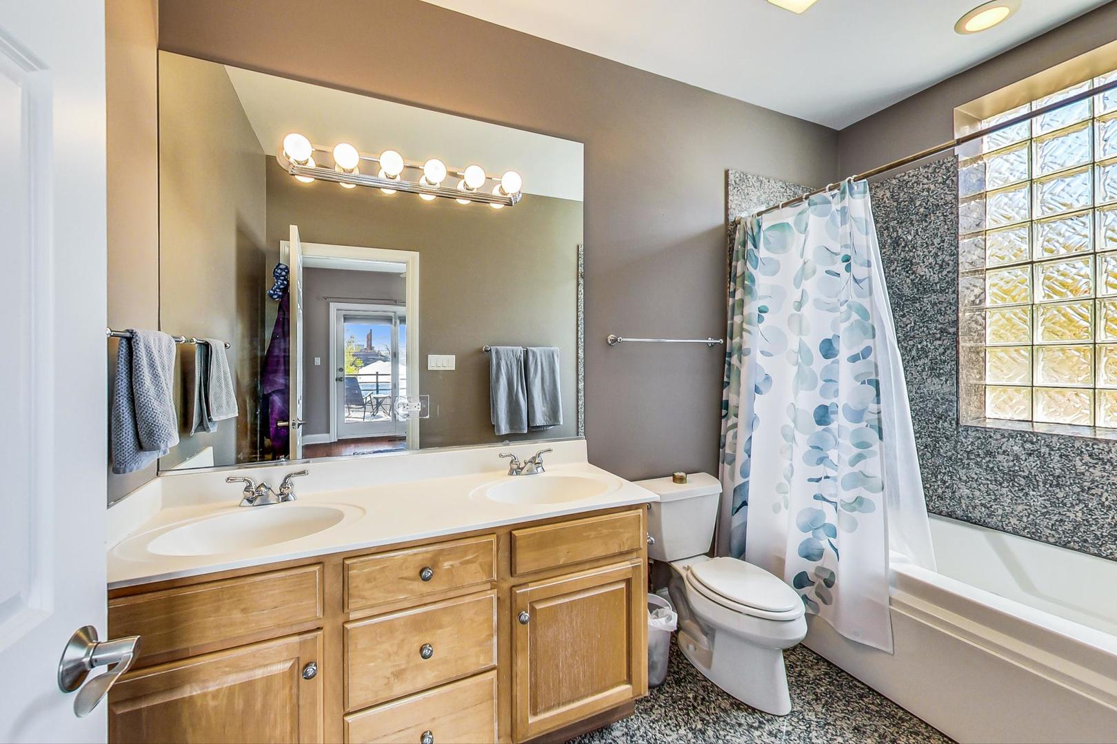 1033 West Taylor Street, Unit 2E Chicago, IL 60607 - Photo 11 of 20 a bathroom with a toilet sink and mirror