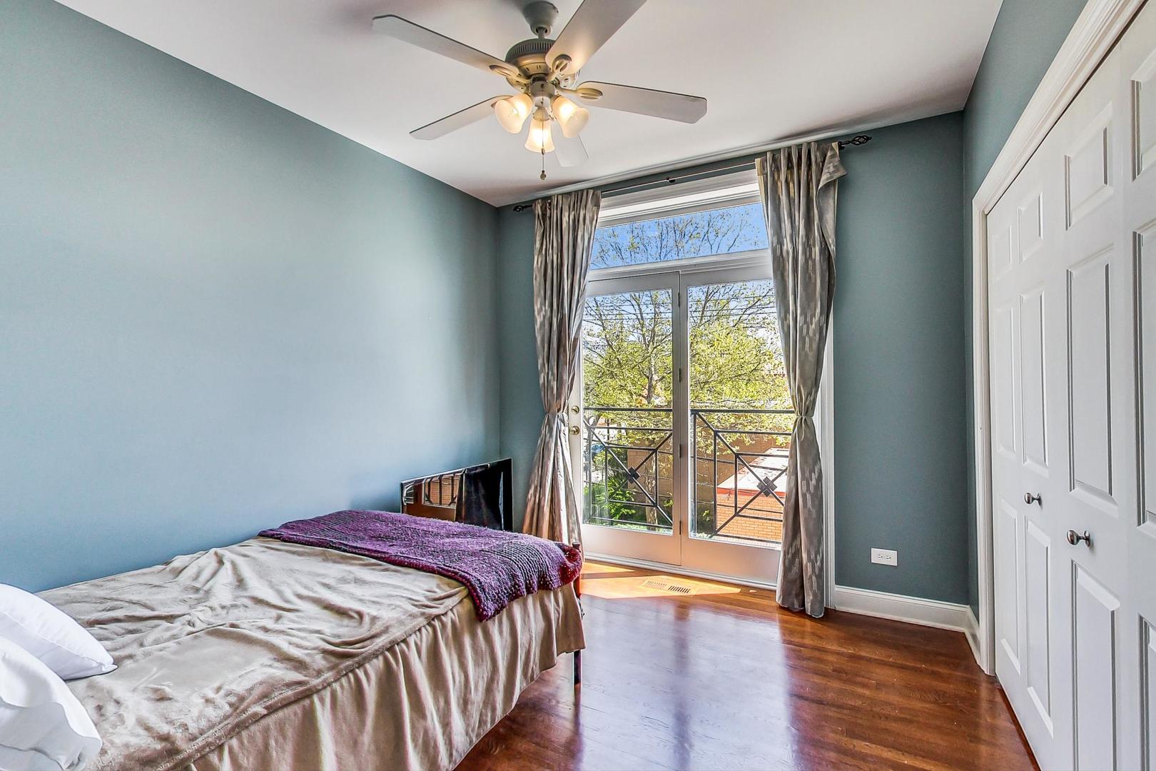 1033 West Taylor Street, Unit 2E Chicago, IL 60607 - Photo 13 of 20 a bedroom with a bed and a large window