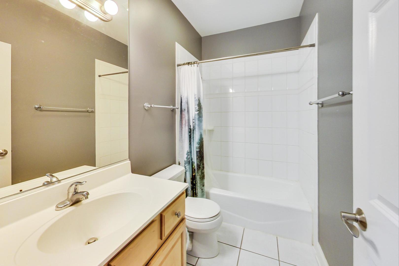 1033 West Taylor Street, Unit 2E Chicago, IL 60607 - Photo 14 of 20 a bathroom with a sink toilet and shower