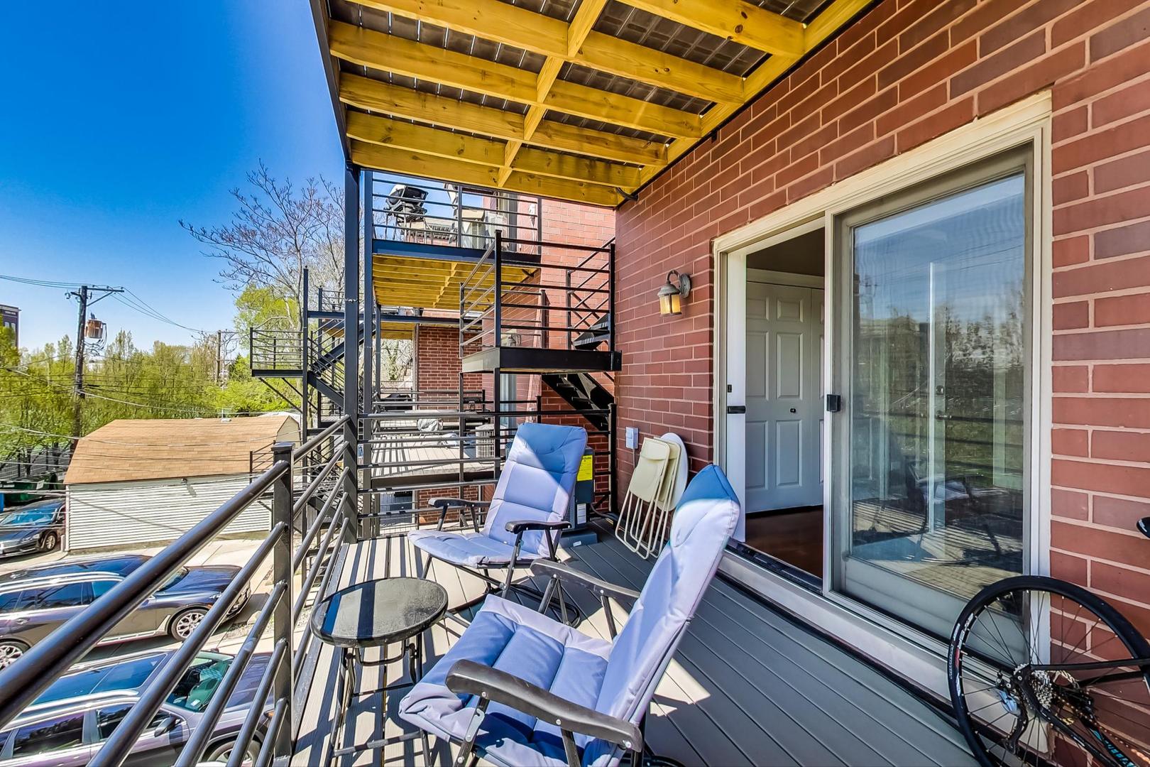 1033 West Taylor Street, Unit 2E Chicago, IL 60607 - Photo 16 of 20 a view of a patio with table and chairs with wooden floor and fence