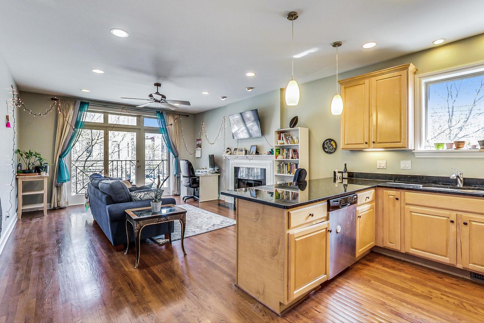 1033 West Taylor Street, Unit 2E Chicago, IL 60607 - Photo 2 of 20 a kitchen with stainless steel appliances granite countertop wooden floors stove top oven and sink