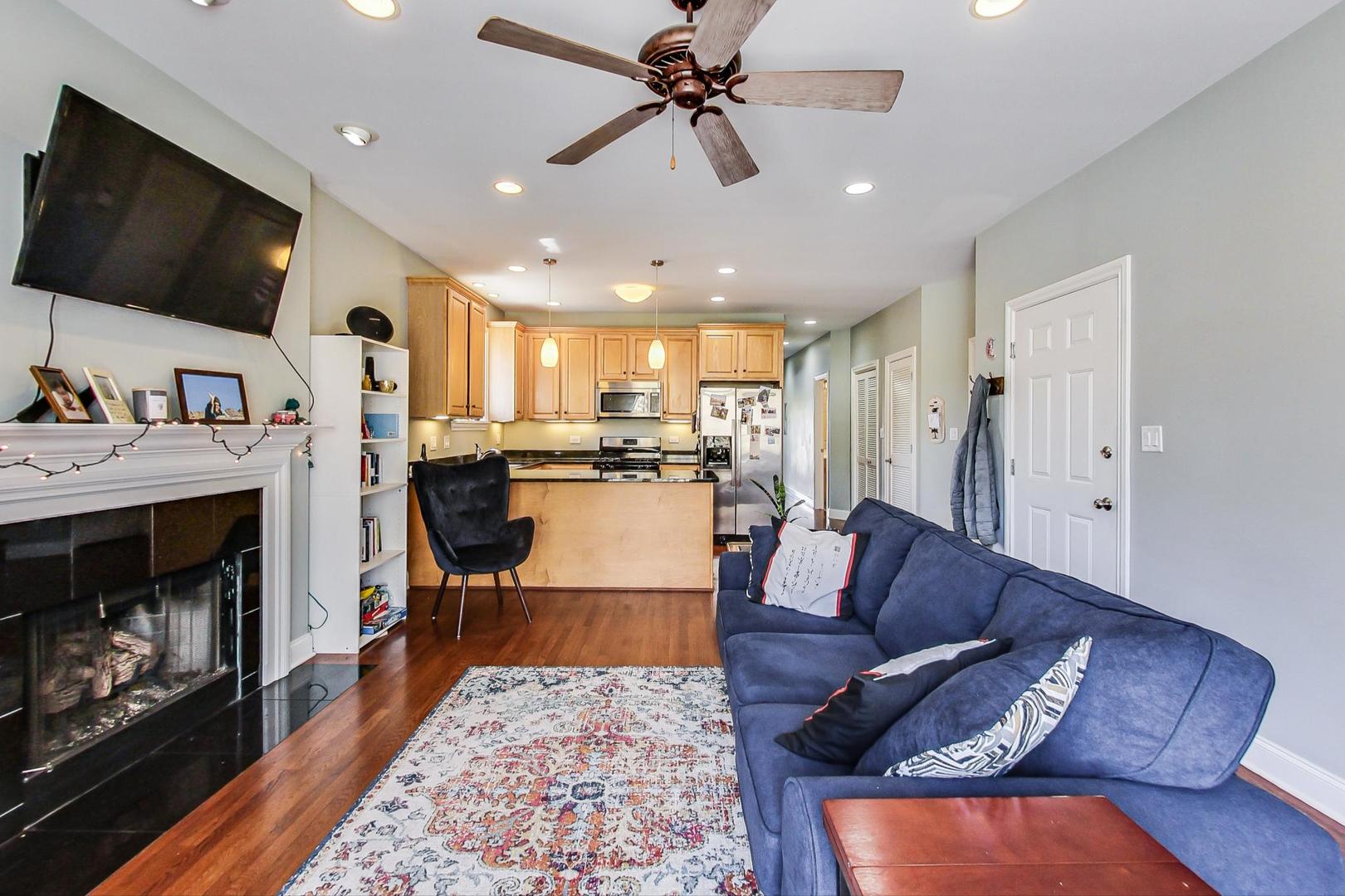 1033 West Taylor Street, Unit 2E Chicago, IL 60607 - Photo 5 of 20 a living room with furniture and a flat screen tv