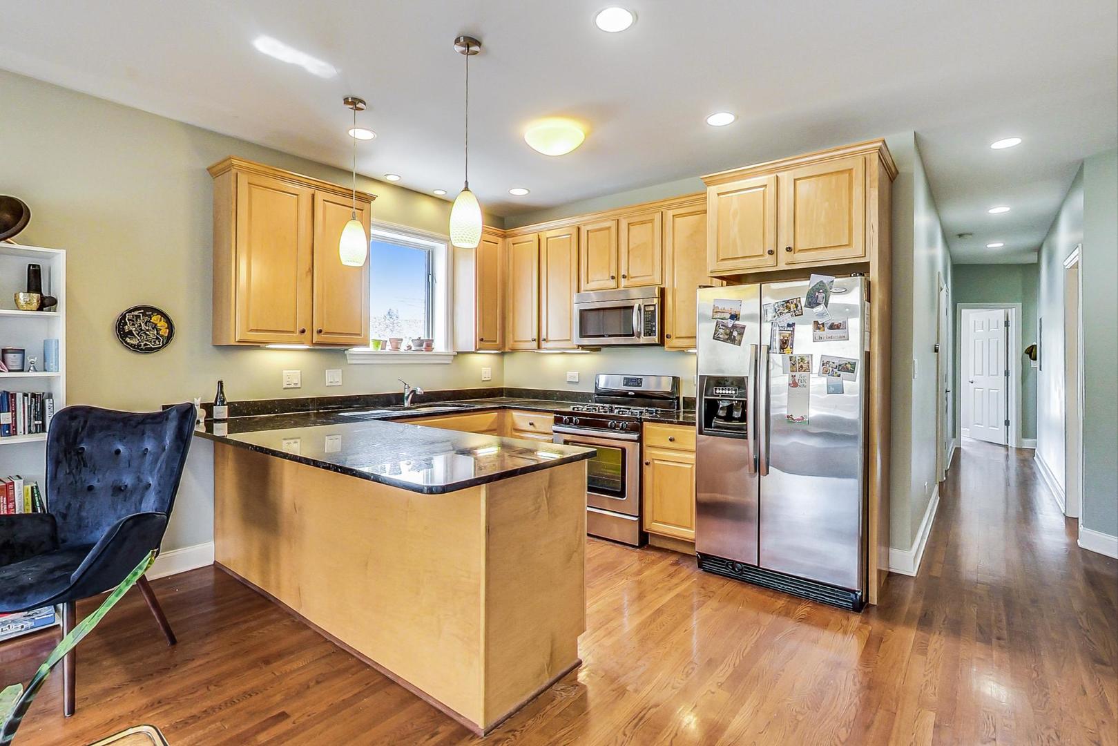 1033 West Taylor Street, Unit 2E Chicago, IL 60607 - Photo 6 of 20 a kitchen with stainless steel appliances granite countertop a refrigerator a stove top oven and a refrigerator
