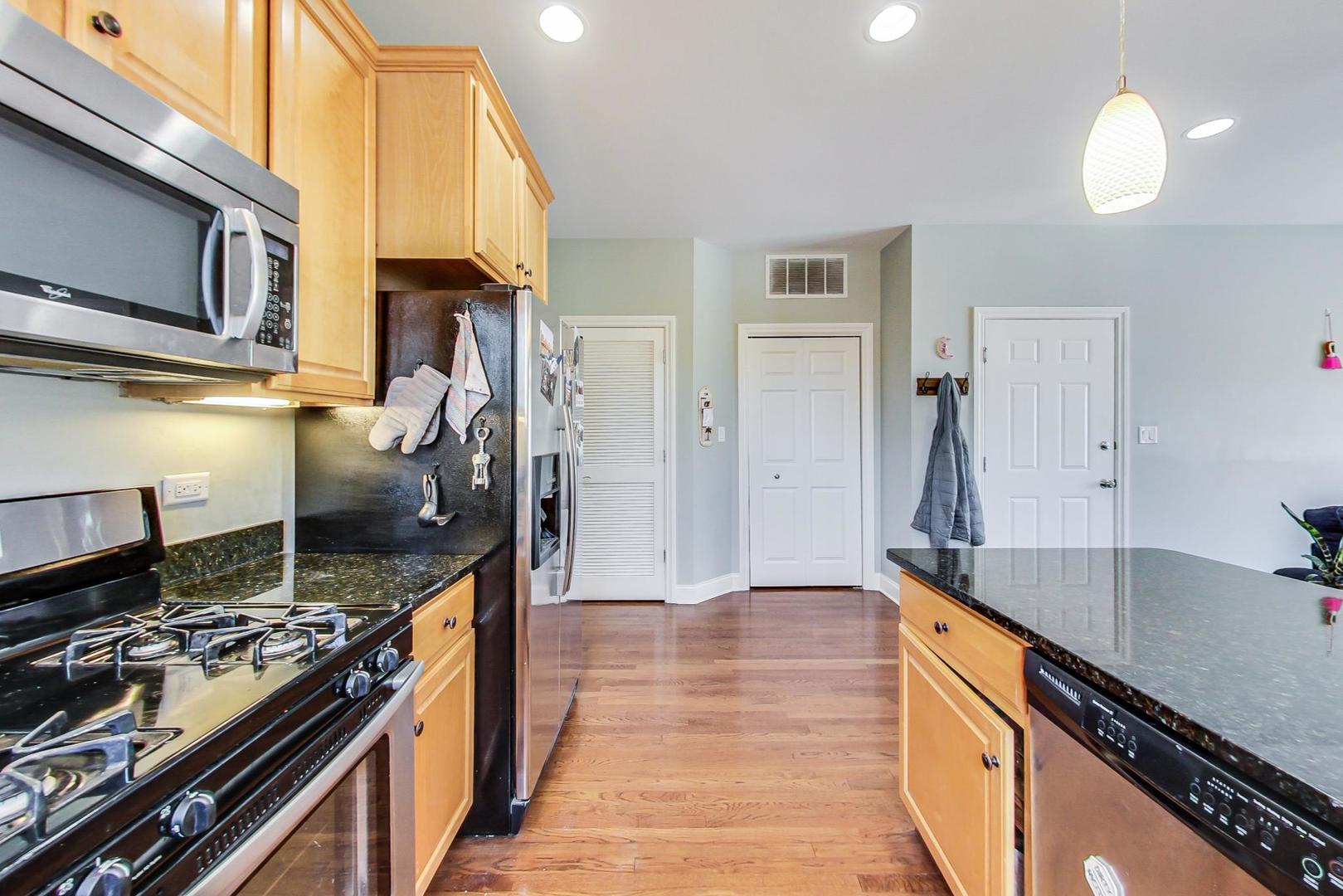 1033 West Taylor Street, Unit 2E Chicago, IL 60607 - Photo 8 of 20 a kitchen with stainless steel appliances granite countertop a stove and a sink