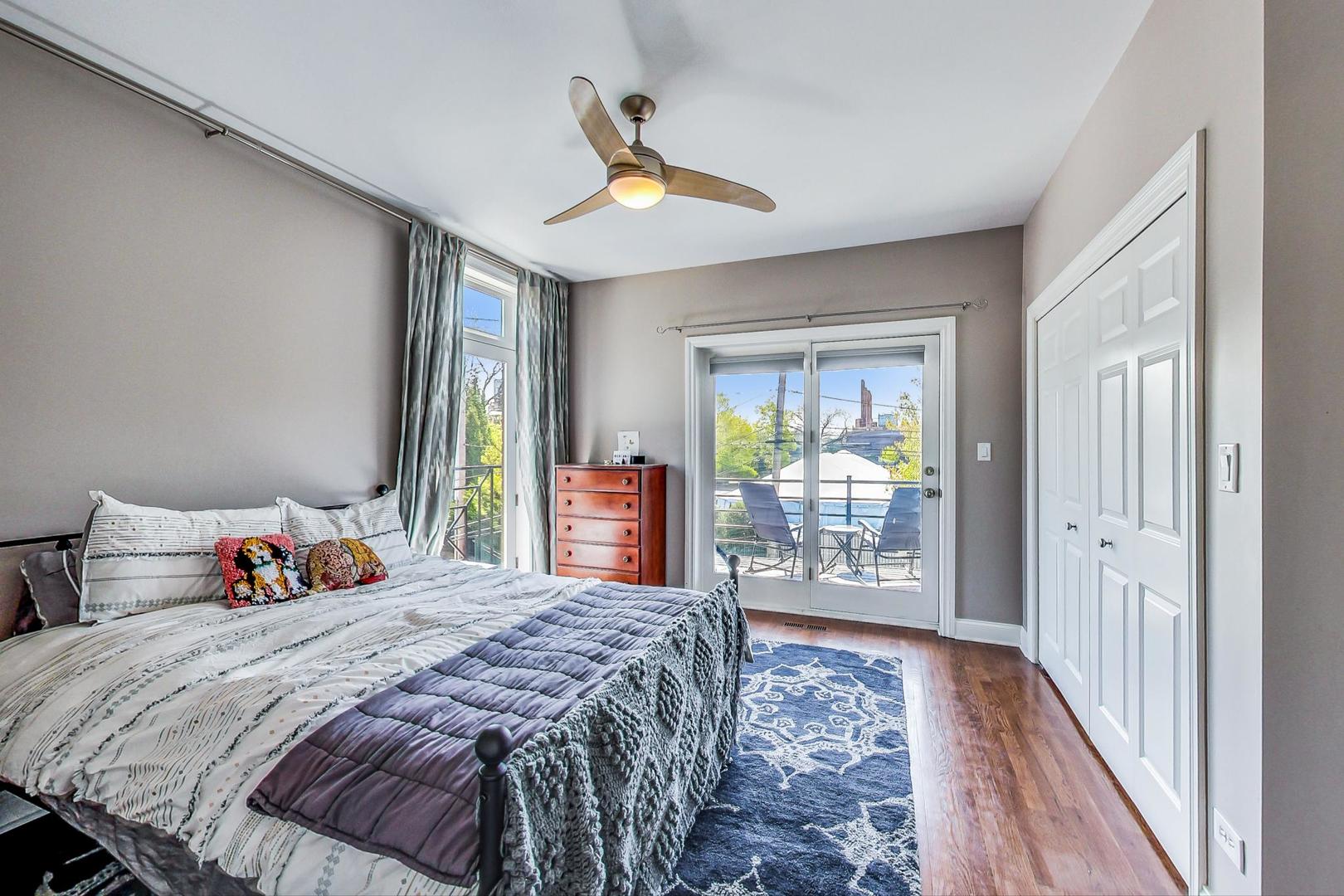 1033 West Taylor Street, Unit 2E Chicago, IL 60607 - Photo 9 of 20 a bedroom with a large bed and a large window