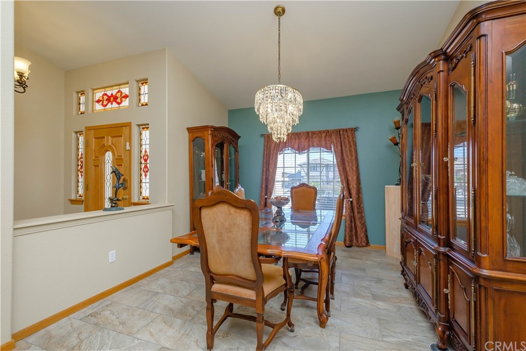 16196 Ridge View Drive Apple Valley, CA 92307 - Photo 11 of 68 a dining room with furniture a chandelier and window