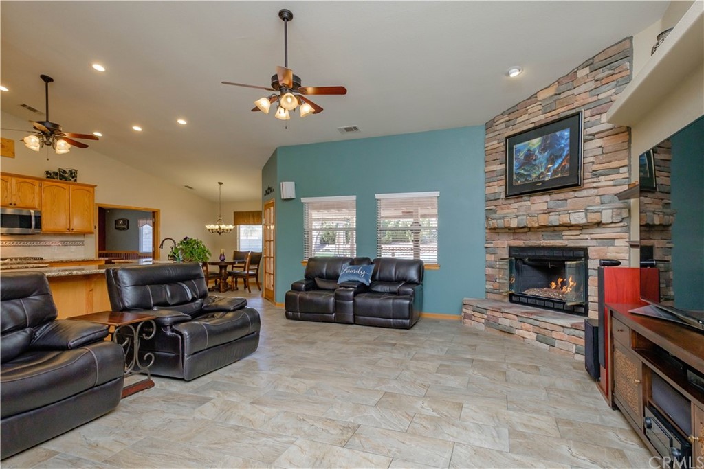 16196 Ridge View Drive Apple Valley, CA 92307 - Photo 13 of 68 a living room with furniture a fireplace and a flat screen tv