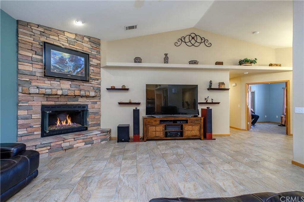 16196 Ridge View Drive Apple Valley, CA 92307 - Photo 14 of 68 a living room with furniture a flat screen tv and a fireplace