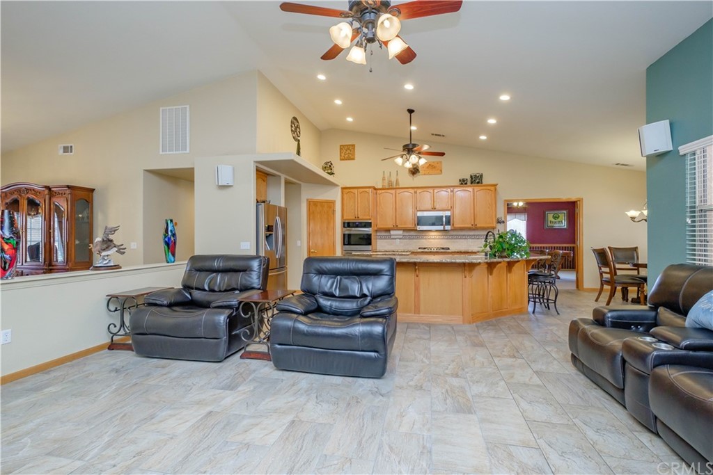 16196 Ridge View Drive Apple Valley, CA 92307 - Photo 16 of 68 a living room with kitchen view and a chandelier