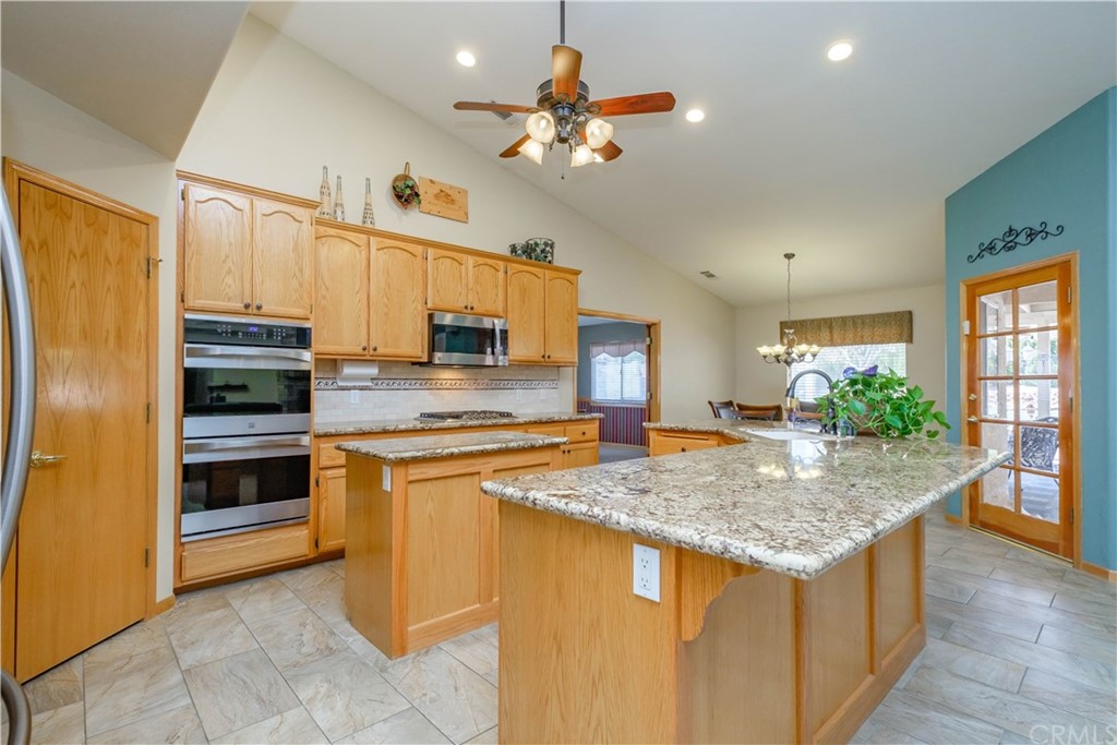 16196 Ridge View Drive Apple Valley, CA 92307 - Photo 17 of 68 a kitchen with stainless steel appliances granite countertop a stove refrigerator and a sink