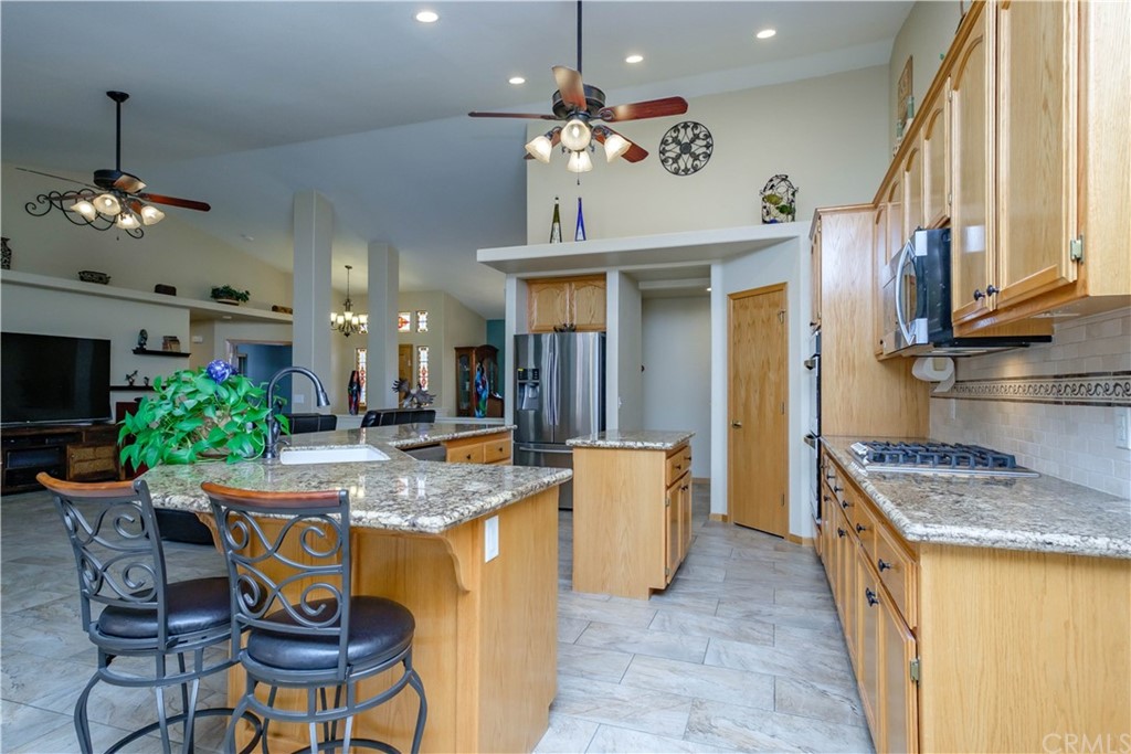 16196 Ridge View Drive Apple Valley, CA 92307 - Photo 18 of 68 a kitchen with stainless steel appliances granite countertop a sink a stove and a refrigerator