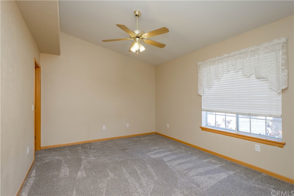 16196 Ridge View Drive Apple Valley, CA 92307 - Photo 27 of 68 a view of an empty room with chandelier fan and fire place