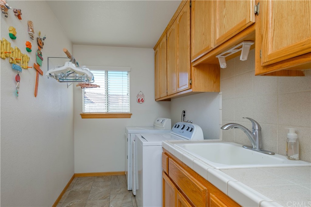 16196 Ridge View Drive Apple Valley, CA 92307 - Photo 33 of 68 a utility room with dryer and washer
