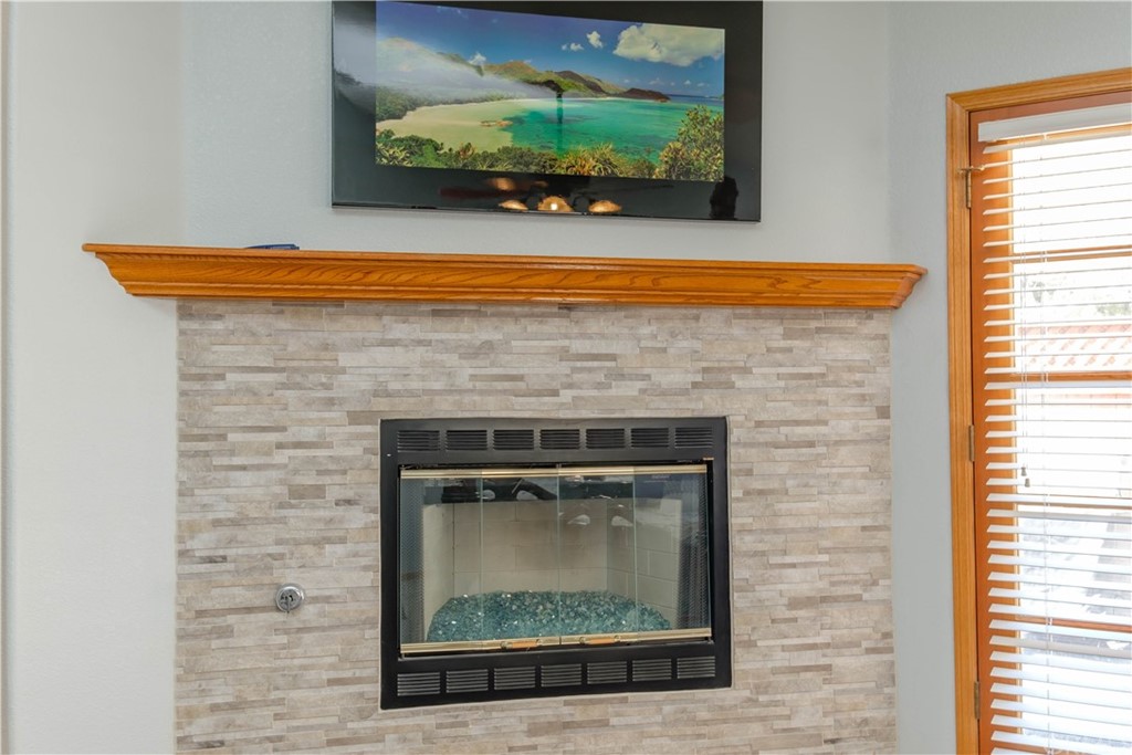 16196 Ridge View Drive Apple Valley, CA 92307 - Photo 37 of 68 a view of an empty room with a fireplace and a window