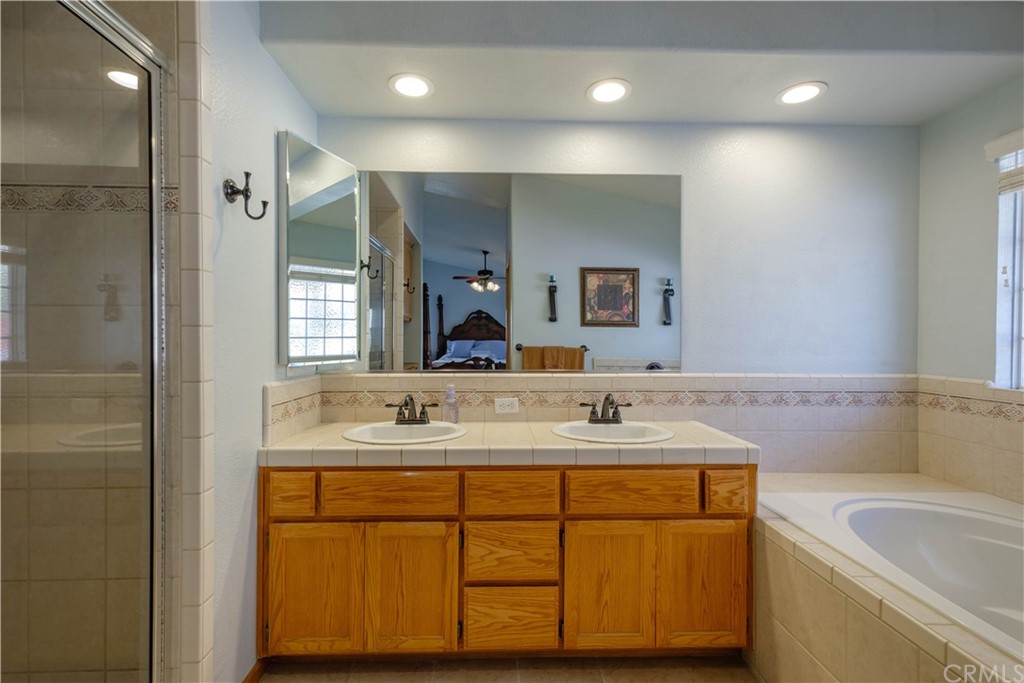 16196 Ridge View Drive Apple Valley, CA 92307 - Photo 39 of 68 a bathroom with a sink double vanity granite tub and a mirror