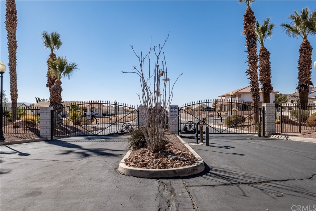 16196 Ridge View Drive Apple Valley, CA 92307 - Photo 67 of 68 a table and chairs with some potted plants in front of house