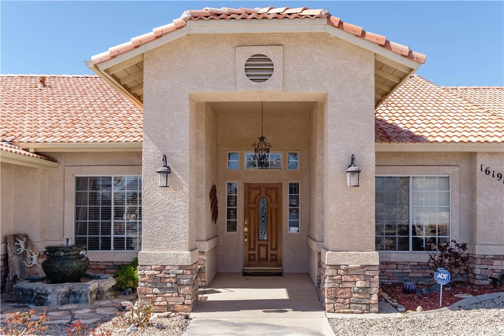 16196 Ridge View Drive Apple Valley, CA 92307 - Photo 8 of 68 a front view of a house with pots