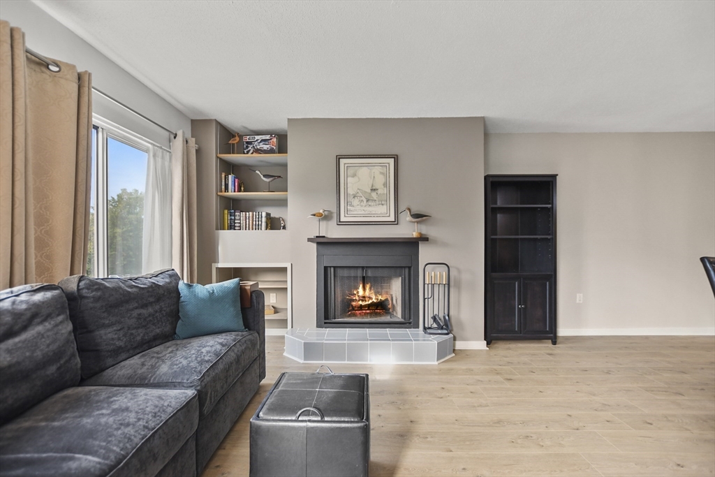 431 Place Lane, Unit 431 Woburn, MA 01801 - Photo 11 of 38 a living room with furniture and a fireplace