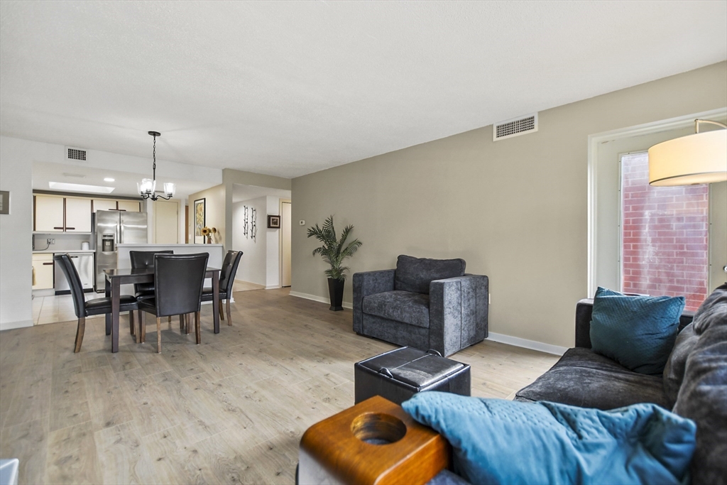 431 Place Lane, Unit 431 Woburn, MA 01801 - Photo 12 of 38 a view of a livingroom with furniture and wooden floor
