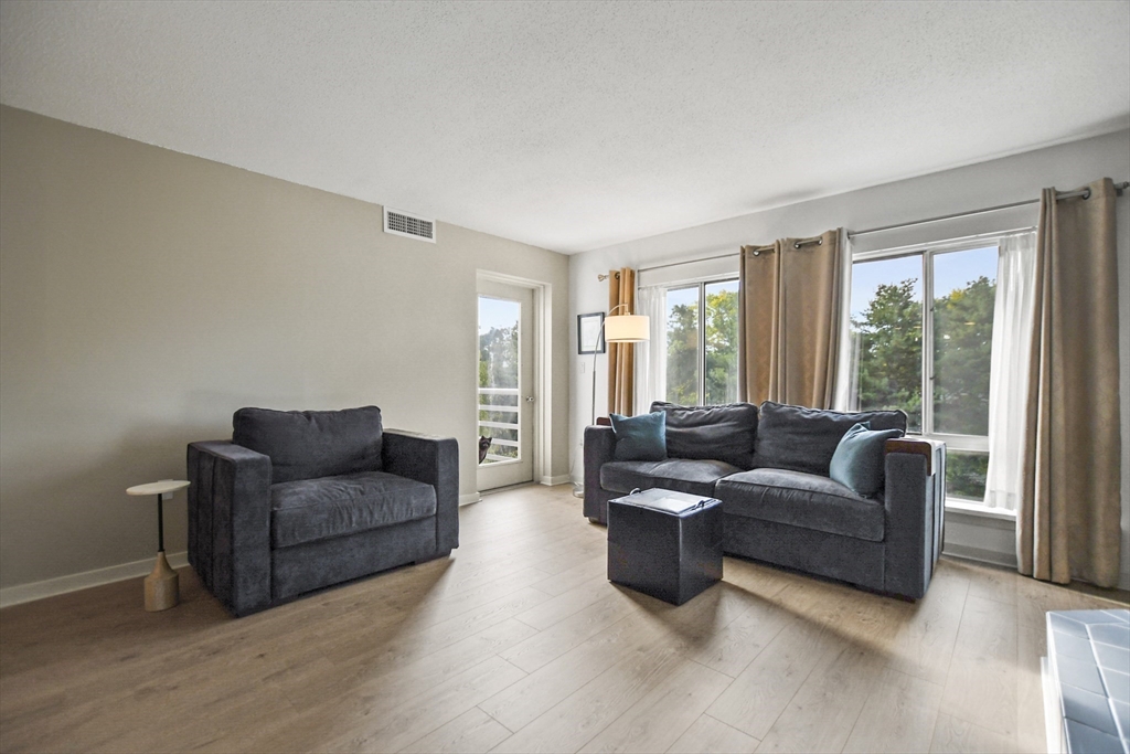 431 Place Lane, Unit 431 Woburn, MA 01801 - Photo 13 of 38 a living room with furniture and a large window