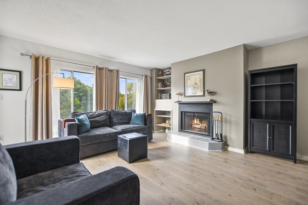 431 Place Lane, Unit 431 Woburn, MA 01801 - Photo 15 of 38 a living room with furniture and a fireplace