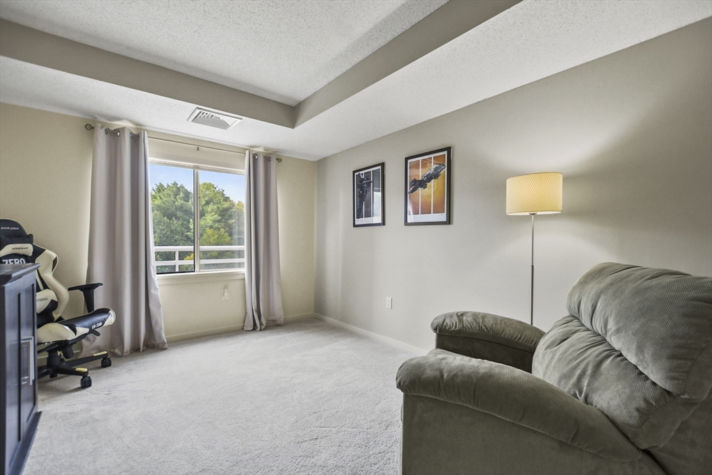 431 Place Lane, Unit 431 Woburn, MA 01801 - Photo 16 of 38 a living room with furniture and a window