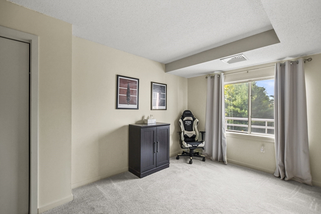 431 Place Lane, Unit 431 Woburn, MA 01801 - Photo 19 of 38 a view of a livingroom with workspace and a window