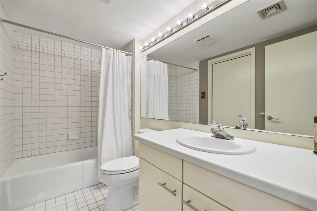 431 Place Lane, Unit 431 Woburn, MA 01801 - Photo 20 of 38 a bathroom with a sink a toilet and shower