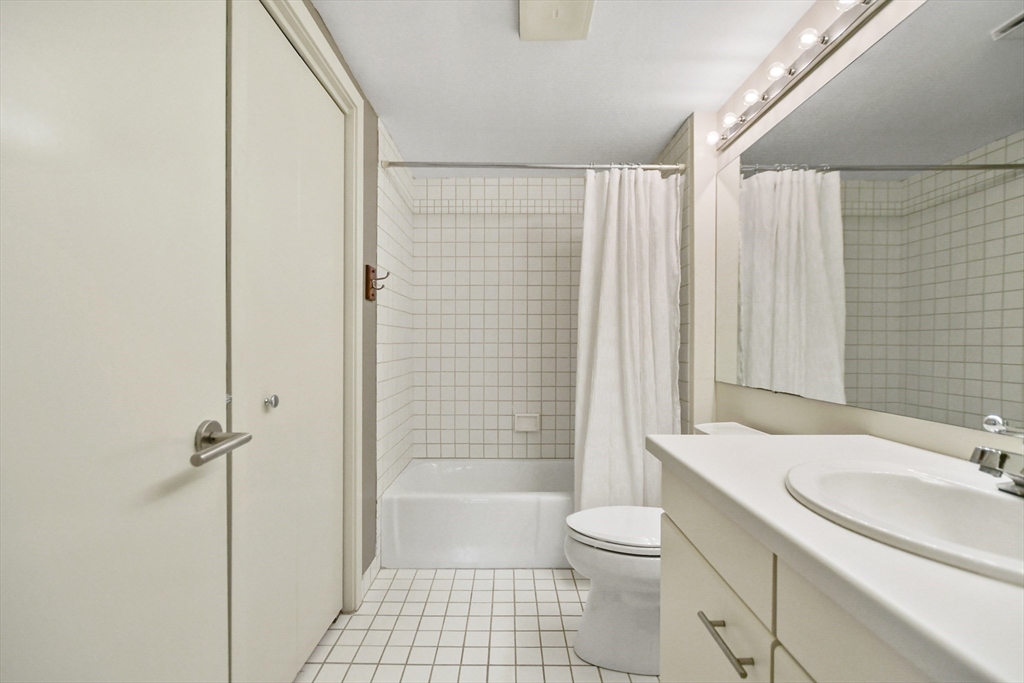 431 Place Lane, Unit 431 Woburn, MA 01801 - Photo 21 of 38 a bathroom with a sink a toilet and shower