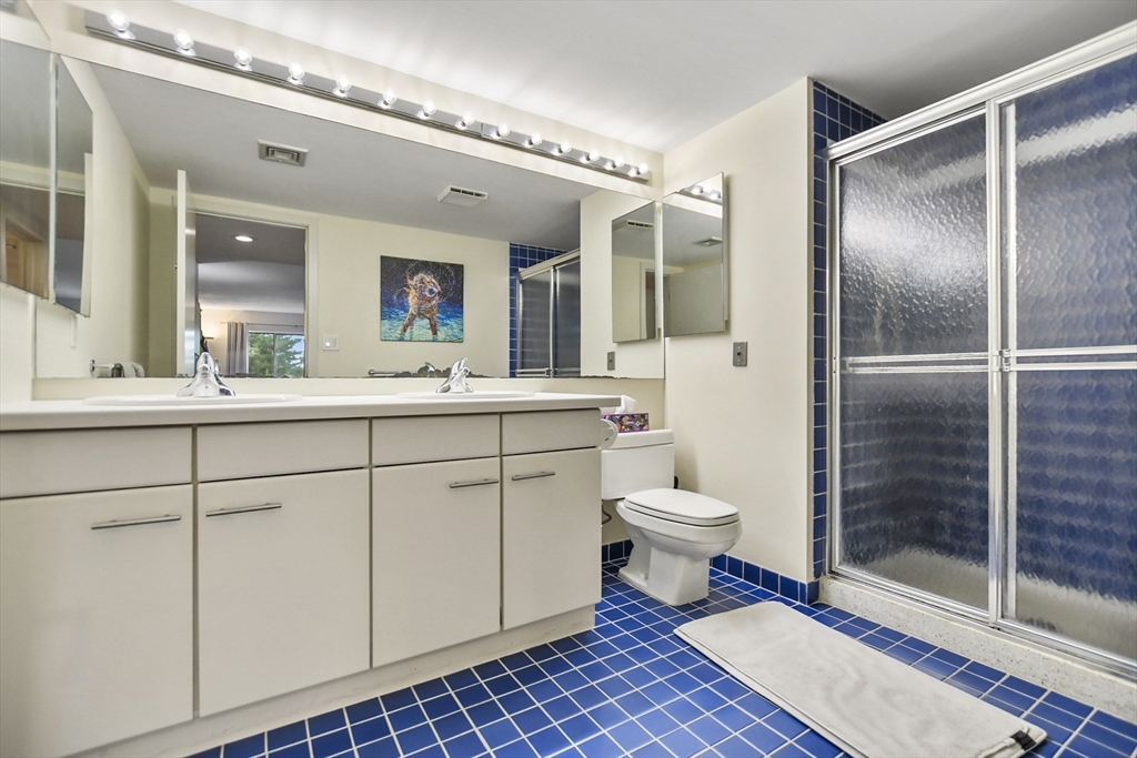 431 Place Lane, Unit 431 Woburn, MA 01801 - Photo 22 of 38 a bathroom with a toilet sink and a shower