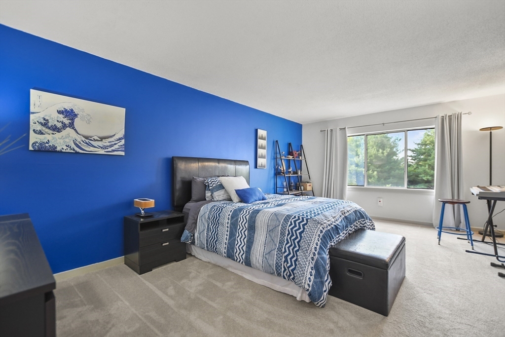 431 Place Lane, Unit 431 Woburn, MA 01801 - Photo 23 of 38 a bed room with a bed and a couch