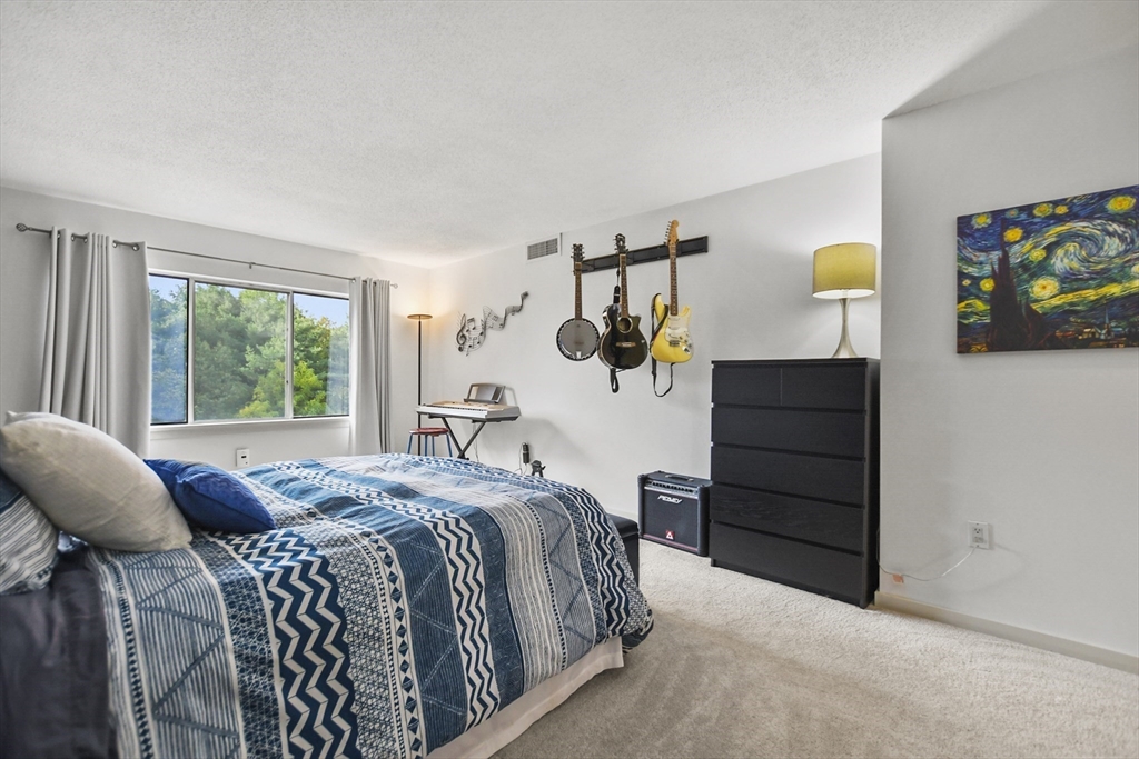 431 Place Lane, Unit 431 Woburn, MA 01801 - Photo 24 of 38 a bedroom with a bed and a window
