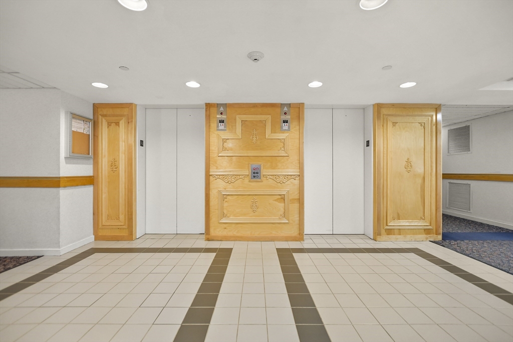 431 Place Lane, Unit 431 Woburn, MA 01801 - Photo 31 of 38 a view of a hallway with wooden floor and windows