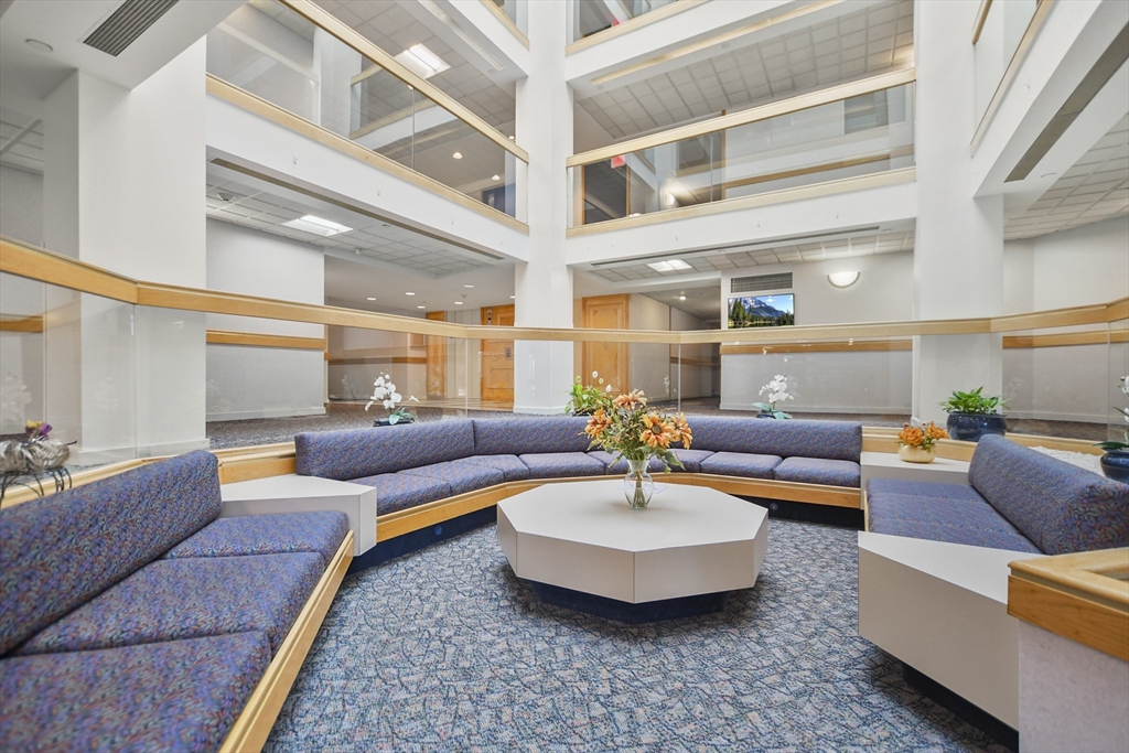 431 Place Lane, Unit 431 Woburn, MA 01801 - Photo 32 of 38 a living room with furniture and a large window
