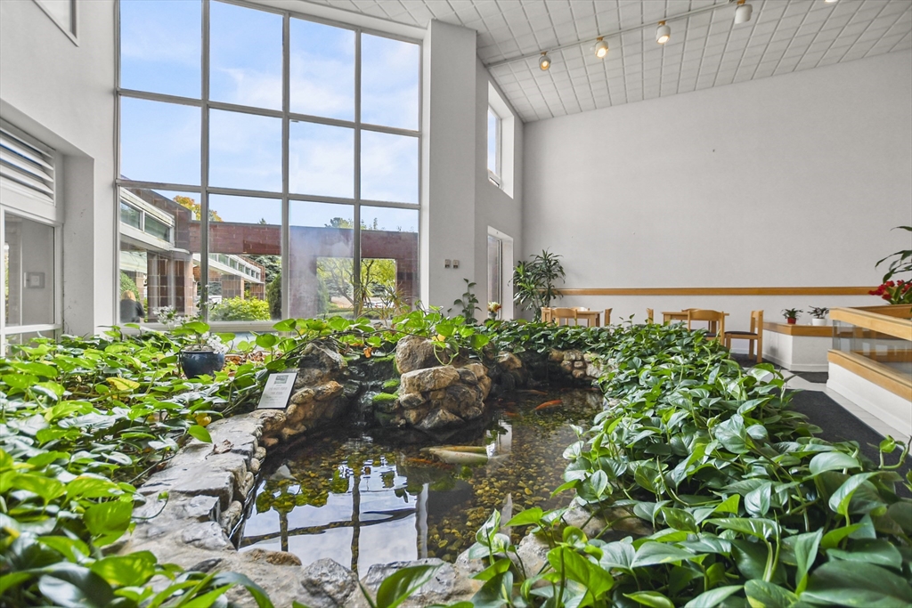 431 Place Lane, Unit 431 Woburn, MA 01801 - Photo 33 of 38 a view of a chair and table in a garden