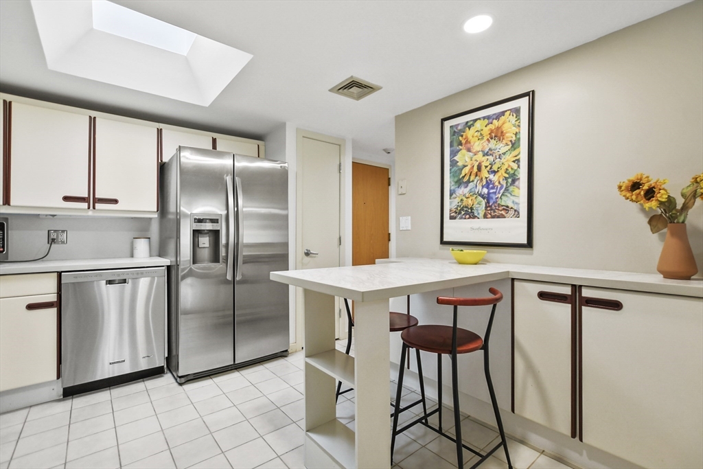 431 Place Lane, Unit 431 Woburn, MA 01801 - Photo 5 of 38 a kitchen with stainless steel appliances a refrigerator and a stove top oven