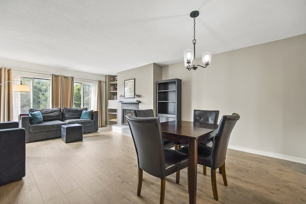 431 Place Lane, Unit 431 Woburn, MA 01801 - Photo 8 of 38 a view of a dining room with furniture window and wooden floor