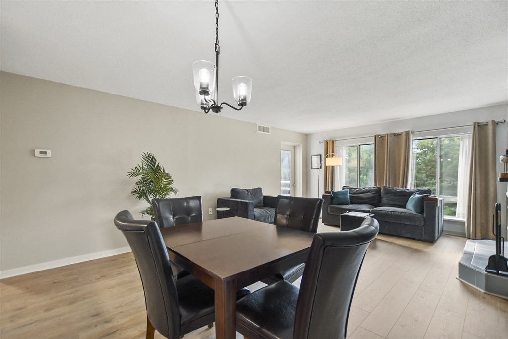 431 Place Lane, Unit 431 Woburn, MA 01801 - Photo 9 of 38 a view of a dining room with furniture window and outside view