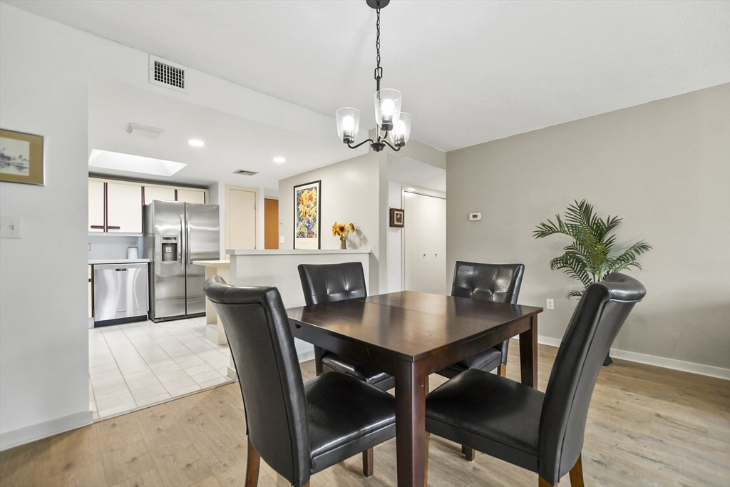 431 Place Lane, Unit 431 Woburn, MA 01801 - Photo 10 of 38 a view of a dining room with furniture and wooden floor