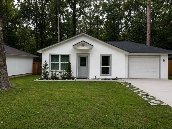 a front view of a house with a garden