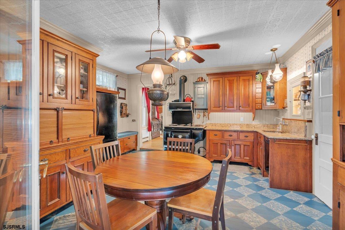 56 Main Street Port Republic, NJ 08241 - Photo 15 of 44 a kitchen with stainless steel appliances kitchen island granite countertop a table chairs in it and a window